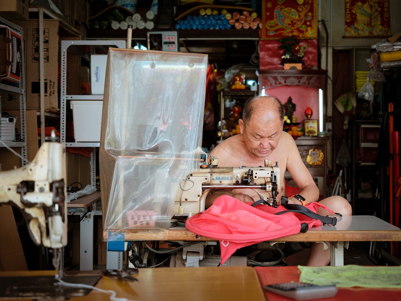 our-story-02 traditional-tailor-at-work-in-sewing-studio-32618426